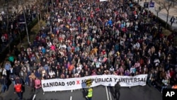 Protesters gather to march to support the public heath service in one of four columns which will meet in the center of Madrid, Spain, Feb. 12, 2023. 