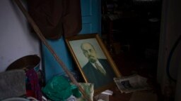 A portrait of Lenin sits on the floor of a house that was occupied by Russian soldiers in Kalynivske, Ukraine, Jan. 28, 2023.