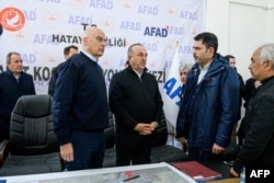 This handout photograph taken and released, Feb. 12, 2023 by the Greek Foreign Ministry shows Greece's Foreign Minister Nikos Dendias (L) and his Turkish counterpart Mevlut Cavusoglu during their visit to Adana, Turkey. (Greek Foreign Ministry/AFP)