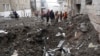 Emergency and municipal workers clear the rubble from a residential building which was hit by a Russian rocket, in the city center of Kharkiv, Feb. 5, 2023.