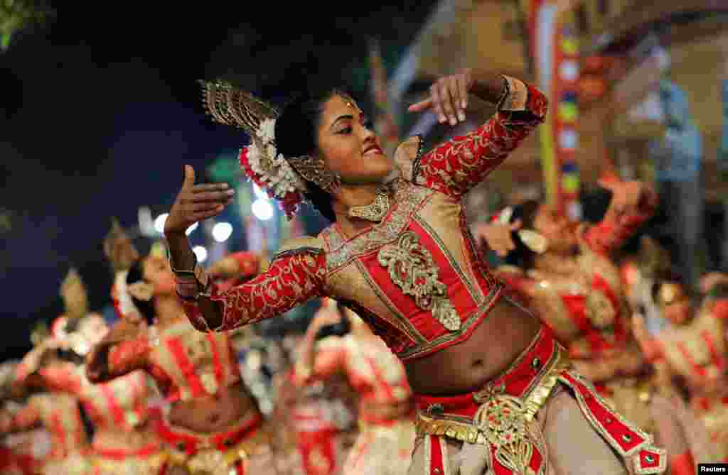 Traditional dancers perform during the annual Nawam Maha Perahera of Gangaramaya Buddhist temple in Colombo, Sri Lanka.