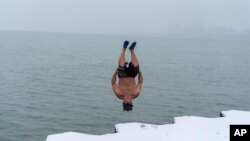 'The Great Lake Jumper' Dan O'Conor takes a plunge into the frigid waters of Lake Michigan, as he does every morning, Jan. 26, 2023, in Chicago.