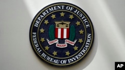 FILE - An FBI seal is seen on a wall in Omaha, Nebraska, Aug. 10, 2022.