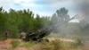 FILE - Ukrainian soldiers fire at Russian positions from a U.S.-supplied M777 howitzer in Ukraine's eastern Donetsk region, June 18, 2022. As the anniversary of the Russian invasion of Ukraine nears, some Americans are growing weary of providing support to Ukraine.