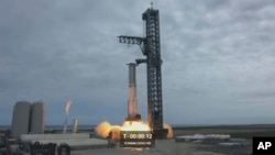 In this image from video made available by SpaceX, a Starship first-stage Super Heavy booster performs an engine-firing test at the launch pad in Boca Chica, Texas, Feb. 9, 2023. 