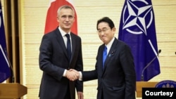 NATO Secretary-General Jens Stoltenberg and Japan's Prime Minister Fumio Kishida shake hands after holding a joint media briefing on January 31, 2023 in Tokyo, Japan. 