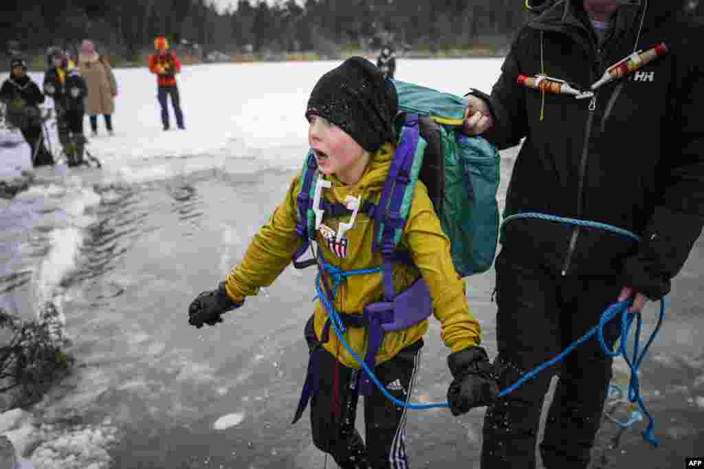 A 5th grade student from Vaxmora School in Sollentuna, north of Stockholm, Sweden, takes part in an exercise teaching them what to do when falling through the ice.