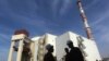 FILE - Iranian workers stand in front of the Bushehr nuclear power plant, about 1,200 km (746 miles) south of Tehran October 26, 2010. 