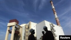 FILE - Iranian workers stand in front of the Bushehr nuclear power plant, about 1,200 km (746 miles) south of Tehran October 26, 2010. 
