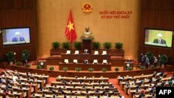 FILE - Vietnam's Communist Party general secretary Nguyen Phu Trong (back R) addresses the opening session of the newly-elected 15th National Assembly's first parliament session in Hanoi, July 20, 2021. 