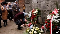 Holocaust survivors and former Auschwitz inmates attend a wreath lying ceremony in the former Nazi German concentration camp during ceremonies marking the 78th anniversary of its liberation in Oswiecim, Poland, Jan. 27, 2023.