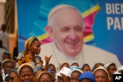 People wait for the arrival of Pope Francis for a meeting with priests, deacons, consecrated people and seminarians, outside the Notre Dame du Congo cathedral in Kinshasa, Democratic Republic of Congo, Feb. 2, 2023.