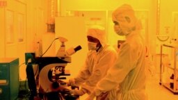 FILE - Researchers wearing bunny suits work inside the semiconductor fabrication lab at the Centre for Nano Science and Engineering (CENSe), situated at the Indian Institute of Science (IISc), in Bangalore on June 30, 2018. 