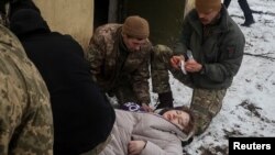Servicemen treat a woman wounded by a Russian missile strike in Kramatorsk, Ukraine Feb. 2, 2023.