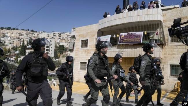 FILE- Israeli police march in the east Jerusalem neighborhood of Silwan, Feb. 10, 2023.