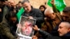 People set on fire a photograph of far-right activist Rasmus Paludan during a protest outside the Swedish consulate in Istanbul, Turkey, Jan. 22, 2023. 