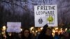 People hold signs referencing Leopard tanks being sent to Ukraine, at a demonstration in Berlin, Germany, Jan. 20, 2023.