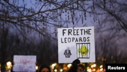 FILE: People hold signs referencing Leopard tanks being sent to Ukraine, at a demonstration in Berlin, Germany, Jan. 20, 2023.