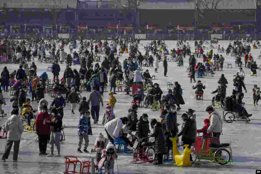 Visitors enjoy skating on the crowded frozen Houhai Lake in Beijing, China.