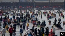 Visitors enjoy skating on the crowded frozen Houhai Lake in Beijing, China, Jan. 30, 2023.