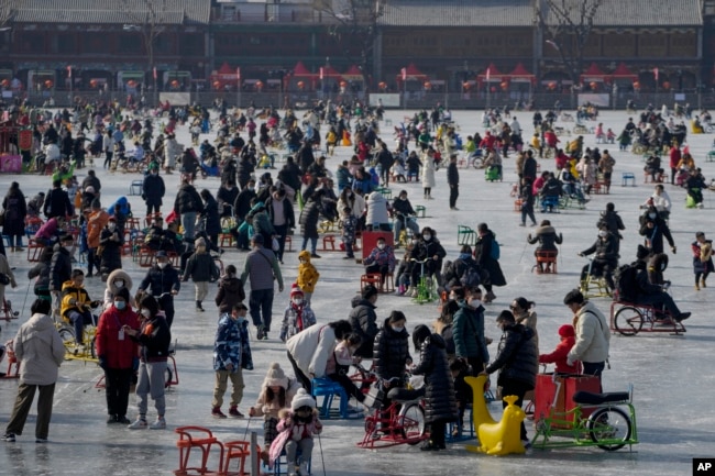 FILE - Visitors enjoy skating on the crowded frozen Houhai Lake in Beijing, China, Jan. 30, 2023. But, do not skate on thin ice! (AP Photo/Andy Wong)