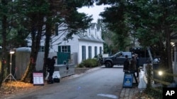 FILE - The access road to President Joe Biden's home in Wilmington, Del., is seen from the media van on Jan. 13, 2023. 