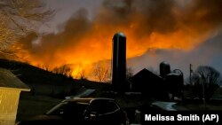 This photo provided by Melissa Smith shows the fire after a train derailed in East Palestine, Ohio, Feb. 3, 2023.