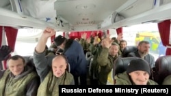 A still image from video released on Feb. 4, 2023, by Russia's Defense Ministry shows who it said are Russian service personnel in a bus after an exchange of prisoners of war at an unknown location during the Russia-Ukraine conflict.