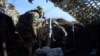 A Ukrainian serviceman gets ready to fire with a mortar from a position near Bakhmut, in Ukraine's Donetsk region, Jan. 27, 2023. There were conflicting claims Sunday over who controls the nearby village of Blahodatne.