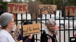 A group of demonstrators protest outside a police precinct in response to the death of Tyre Nichols, who died after being beaten by Memphis police officers, in Memphis, Tenn., Jan. 29, 2023.