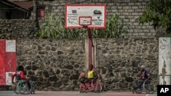 FILE - Paul Mitemberezi, a market vendor who has been disabled since he was 3 because of polio, plays basketball at the North Kivu Paralympic League, in Goma, democratic Republic of Congo, Jan. 17, 2023.