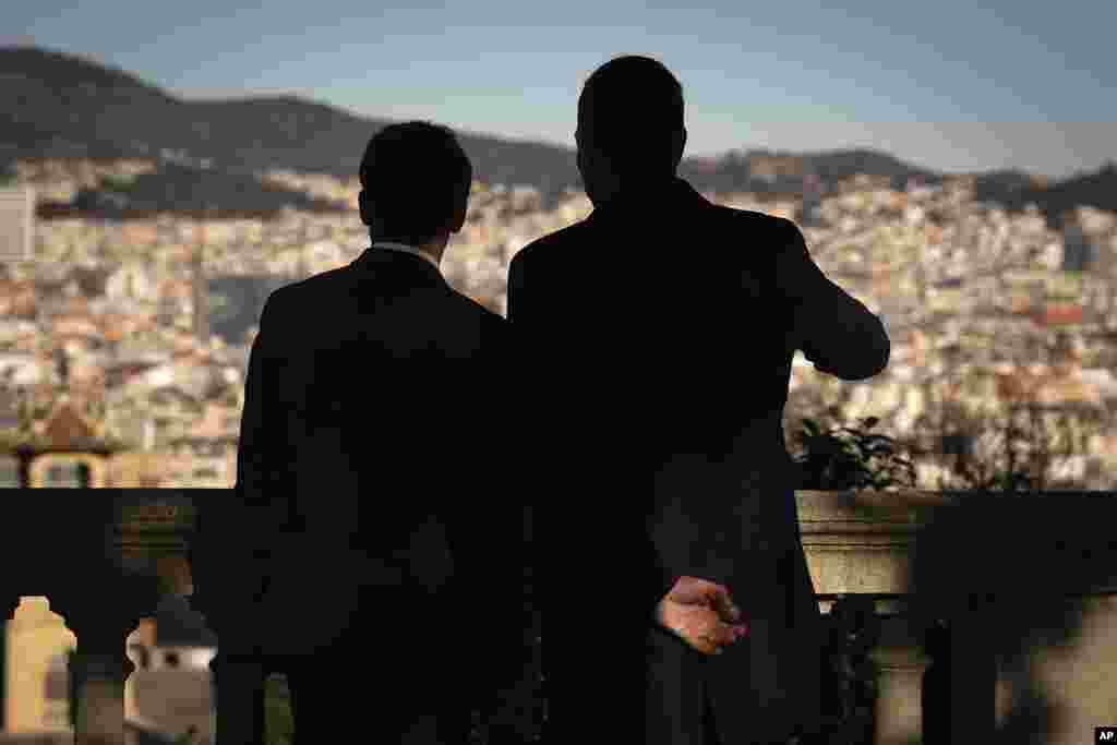 French President Emmanuel Macron, left, talks with Spanish counterpart Pedro Sánchez as they look over Barcelona, Spain.
