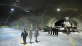 A picture provided by the Iranian Army Office shows Commander-in-Chief of the Iranian Army Major General Abdolrahim Mousavi, right, and Armed Forces Chief of Staff Major General Mohammad Bagheri, center, at Iran's first underground military air base in an undisclosed location.
