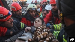 Rescuers carry Muhammed Alkanaas, 12, to an ambulance after they pulled him out five days after the Monday earthquake in Antakya, southern Turkey, Feb. 11, 2023.