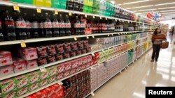 FILE: A shopper in a supermarket soda aisle, in Los Angeles, on April 7, 2011. Food prices have markedly risen in 2022-2023, along with the cost of many other goods. 