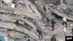 Rescue workers and volunteers conduct search and rescue operations in the rubble of a collasped building, in Diyarbakir, Feb. 6, 2023.