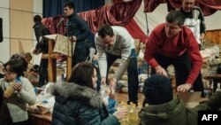 Church members distribute food to local residents after a mass at the Ark of Salvation Church, in Kramatorsk, in Ukraine's eastern Donetsk region, Feb. 12, 2023. 