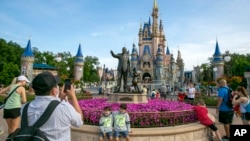 FILE - People visit Magic Kingdom Park at Walt Disney World Resort in Lake Buena Vista, Florida, on April 18, 2022. 