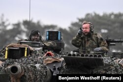 German Defense minister Boris Pistorius rides in a tank as he visits Leopard II tanks that are due to be supplied to Ukraine at the tank brigade Lipperland of Germany's army and part of the Bundeswehr, in Augustdorf, Germany, February 1, 2023.