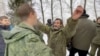 A still image from video released on Feb. 4, 2023 by Russia's Defense Ministry shows who it said are Russian servicemen released in the latest exchange of prisoners of war at an unknown location during the Russia-Ukraine conflict.