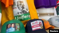 Branded T-shirts and baseball caps with images of Nigerian presidential candidates are displayed at a shopping center in Abuja, Nigeria, Feb. 2, 2023.