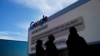 FILE - Workers set up a Google billboard at the Las Vegas Convention Center ahead of the CES technology show on January 2, 2023, in Las Vegas.