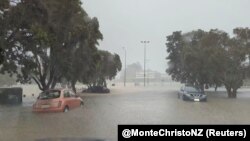 This screen grab from a social media video shows water flooding a street during heavy rainfall in Auckland, New Zealand, Jan. 27, 2023. (Courtesy of @MonteChristoNZ via Reuters)