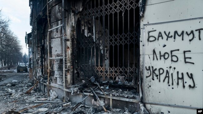 The city center in Bakhmut, Donetsk region, Ukraine, was damaged by Russian shelling, Friday, Feb. 10, 2023. The writing on the wall reads "Bakhmut loves Ukraine."