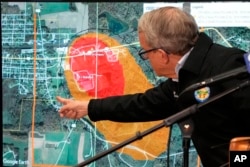 Ohio Gov. Mike DeWine points to a map of East Palestine, that indicates the area that has been evacuated as a result of Norfolk Southern train derailment, after touring the site, Feb. 6, 2023, in East Palestine.