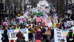 Protesters make their way to the Wisconsin Capitol Rotunda during a march supporting the overturning of the state's near total ban on abortion, in Madison, Wisconsin, Jan. 22, 2023.