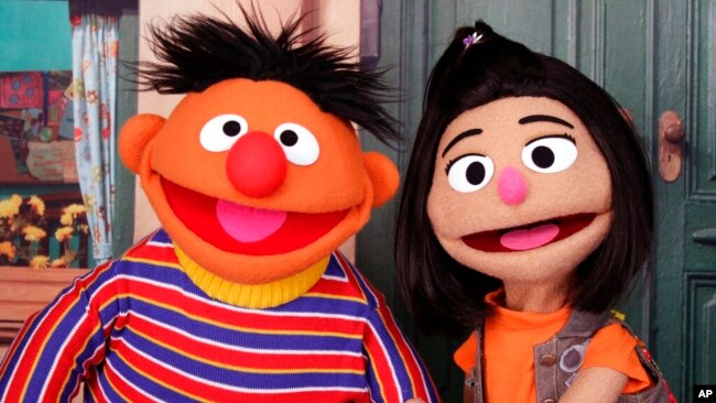 FILE - Ernie, a Muppet from the popular children's series 'Sesame Street,' appears with new character Ji-Young, the first Asian American muppet, on the set of the long-running children's program in New York on Nov. 1, 2021.