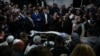 Mourners gather around the bodies of Israeli couple Eli Mizrahi and his wife, Natalie, victims of a shooting attack Friday in east Jerusalem, during their funeral at the cemetery in Beit Shemesh, Israel, Jan. 29, 2023. 