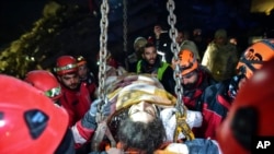 Teams use a crane to rescue Nur Bayraktar in Kahramanmaras, Turkey, Feb. 10, 2023. Emergency crews made a series of dramatic rescues in Turkey on Friday, four days after a catastrophic earthquake killed more than 22,000. 