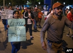 Protesters demand the resignation of Peru's President Dina Boluarte and the closure of Congress, in a residential area in Lima, Jan. 15, 2023.